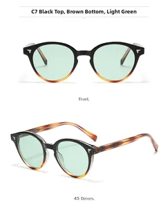 Detail of vintage round sunglasses in black and tortoiseshell frame with green lenses