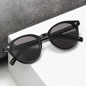 Retro black square sunglasses with silver wing rivets on white geometric display stand