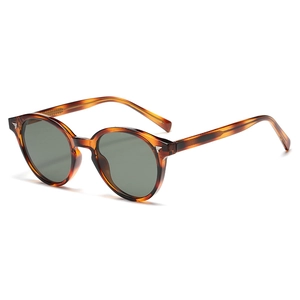 Vintage tortoiseshell round sunglasses with dark green lenses and silver wing metal accents