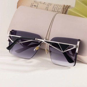 Detail of gradient lenses and silver metal frame with stylish geometric hollow design