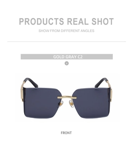 Front view of gold gray rimless sunglasses with metal bridge and transparent lenses
