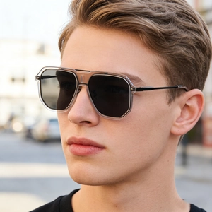Close-up of stylish pilot sunglasses with transparent frames and dark lenses for men