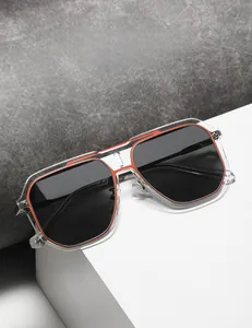 Detail of square double-bridge sunglasses with clear frames and orange inner lining