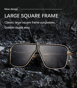 Detail of square sunglasses with gold metal frame and double bridge on dark stone