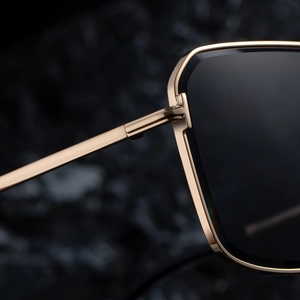 Macro detail of high-quality metal hinges and square frames on gold-tone sunglasses