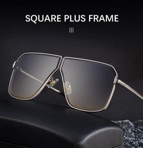 Detail of square oversized sunglasses with metallic double bridge on a premium leather case