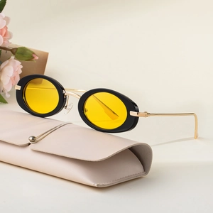 Vintage oval sunglasses with yellow lenses, black frames, and a beige faux leather case