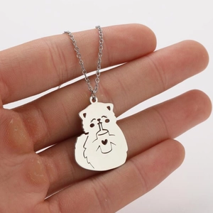 Detailed close-up of cartoon cat pendant necklace with heart cutout in silver stainless steel