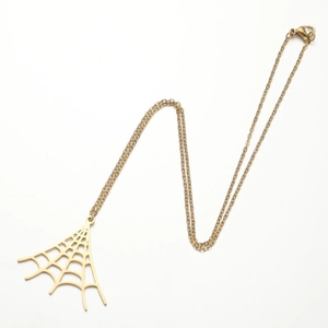 Detailed view of a golden stainless steel spider web pendant with fine hollow design