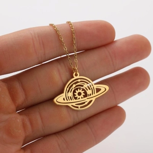 Detailed view of a golden hollow planet pendant with sun motif and orbital rings
