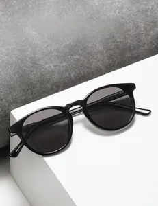 Detailed close-up of fashion round sunglasses TR28030 on a modern white display stand