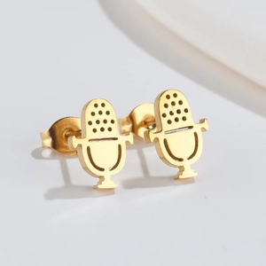 Close-up of golden stainless steel microphone earrings with detailed honeycomb texture