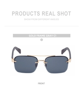 Detail of rimless gold metal frame with double bridge and grey tinted lenses