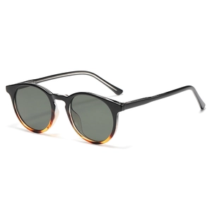 Classic round frame sunglasses featuring black and amber gradient finish with dark lenses