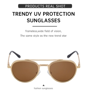 Detail of vintage aviator sunglasses with gold metal frame and brown lenses