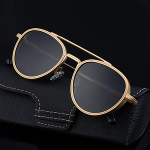 Steampunk round frame sunglasses with gold metal bridge and black leather case