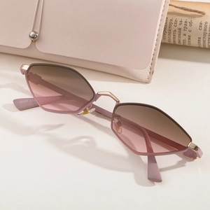 Polygonal rose gold sunglasses with gradient lenses and matching pink leather case