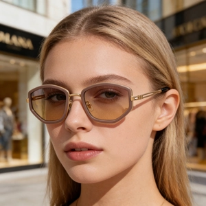 Detail of trendy latte geometric sunglasses with gradient lenses and gold hollow metal arms