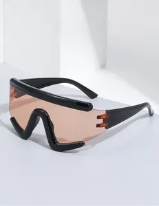 Detail of sports sunglasses featuring glossy black frame and orange transparent lens