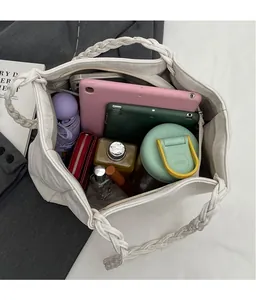Spacious interior of a cream tote bag showing capacity for tablets and daily essentials