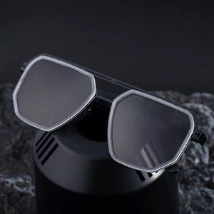 Square polarized sunglasses with matte black frames and double bridge on dark stone background