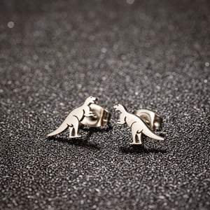 Macro shot of polished silver dinosaur stud earrings with secure butterfly backs