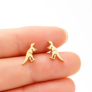Minimalist tiny gold T-Rex dinosaur stud earrings shown on fingers for size