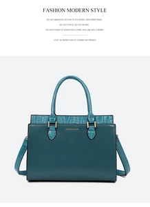 Close-up of peacock green tote bag featuring luxury crocodile pattern embossing and gold text