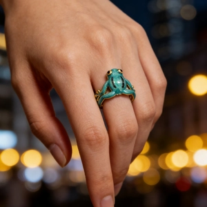 Adjustable green enamel frog ring with gold plating shown on a model against city lights