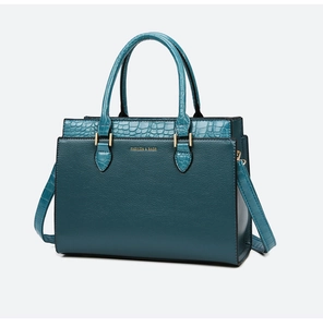 Detailed view of the dark green tote bag with crocodile texture and gold hardware