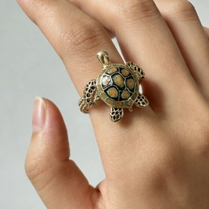 Vintage gold turtle ring with green enamel shell detail and hollowed pattern