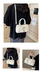 Detailed close-up of bow knot decor and premium PU leather texture on cream cylinder bag
