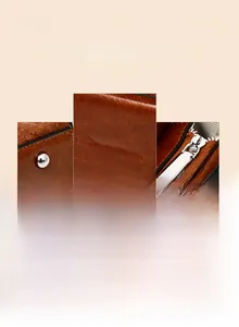 Detail of brown crocodile pattern handbag featuring silver studs and metal zipper
