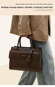 Detail of dark brown crocodile embossed leather handbag with Balado & Bag logo