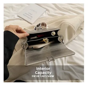 Internal capacity of silver crossbody bag with dual compartments for phone and lipstick