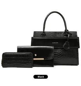 Detailed set of three black bags featuring crocodile texture and silver logo lettering