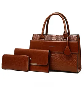 Detailed set of brown crocodile pattern tote bag, purse, and wallet with gold hardware