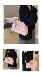 Pink shoulder bag with abstract lettering, silver butterfly clasp and plush charm