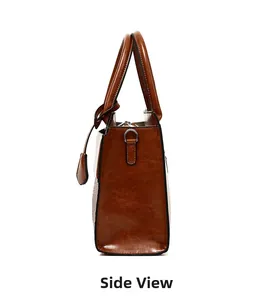 Side view of brown faux leather handbag showing silver D-ring and smooth oil edge
