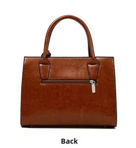 Back view of brown vintage crocodile pattern leather handbag with metal zipper pocket