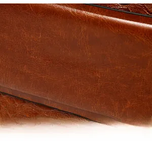 Macro detail of brown crocodile texture leather with silver BALADO & BAG metal logo
