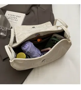 Detail view of the spacious inner compartment of the beige tote bag with daily items