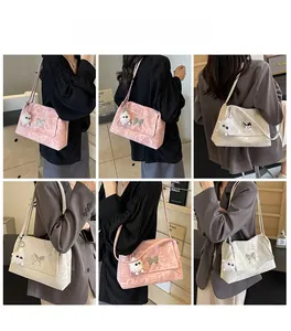 Detail showing pink and off-white tote bags with butterfly buckles and plush pendants