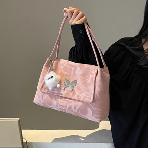 Pink canvas tote bag featuring silver butterfly buckle and white plush pendant detail