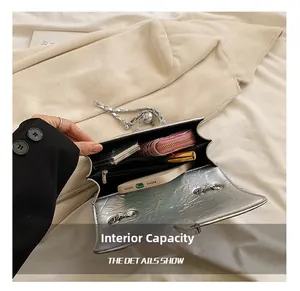 Interior view of silver quilted chain bag showing capacity for phone and wallet