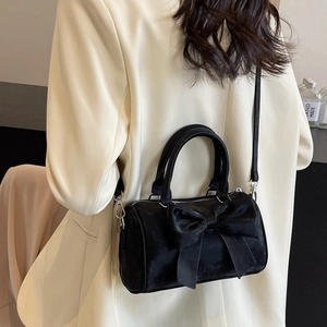 Elegant black velvet bow cylinder bag with silver hardware for women's crossbody style