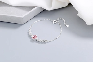 Close-up of pink crystal pendant on silver necklace with fine chain and adjustable clasp