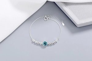 Close-up of S925 sterling silver chain with a blue crystal pendant and small white zircons