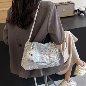 Silver tote bag with Y2K patterns featuring butterfly metal buckle and plush pendant