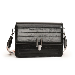 Retro black leather square bag with textured finish and floral print wide shoulder strap